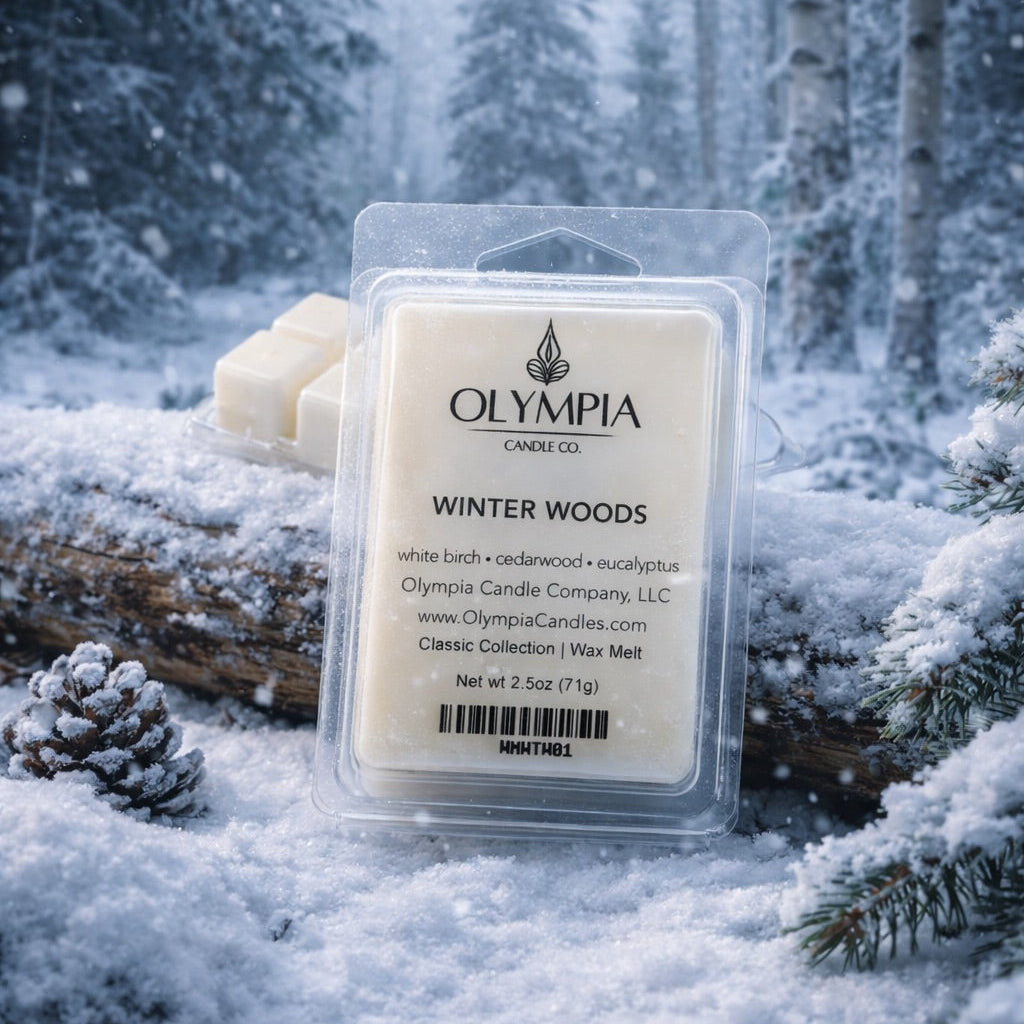 Olympia Candle Co. wax melt package in a snowy forest setting