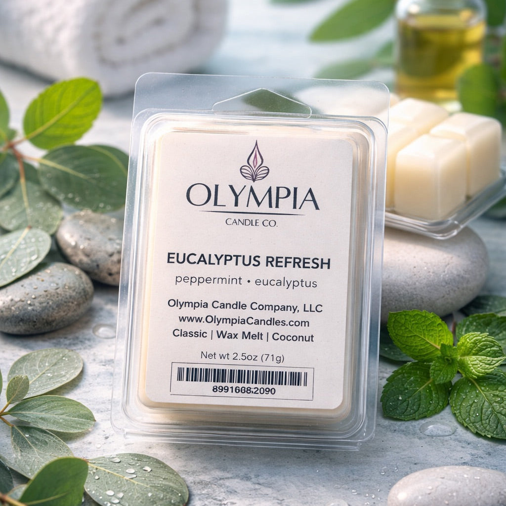 Olympia Candle Co. Eucalyptus Refresh wax melt packaging with eucalyptus leaves and stones in the background