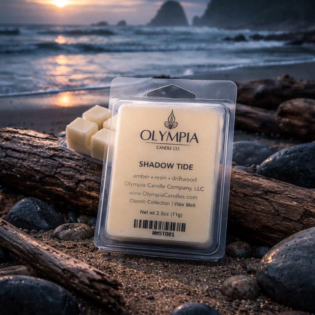 Olympia Candle Co. wax melt package on a beach with sunset in the background