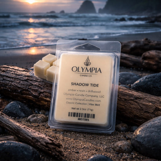 Olympia Candle Co. wax melt package on a beach with sunset in the background