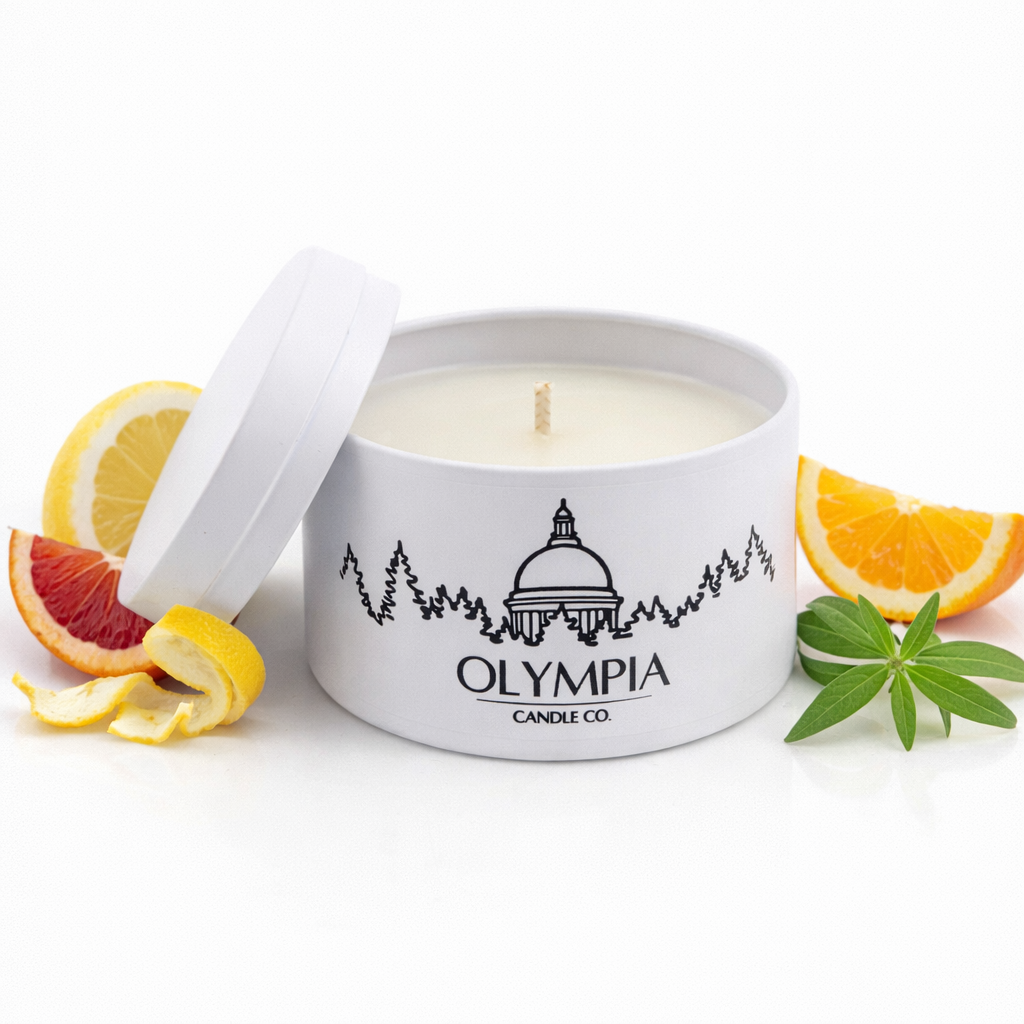 Olympia Candle Co. candle with lemon and orange slices on a white background