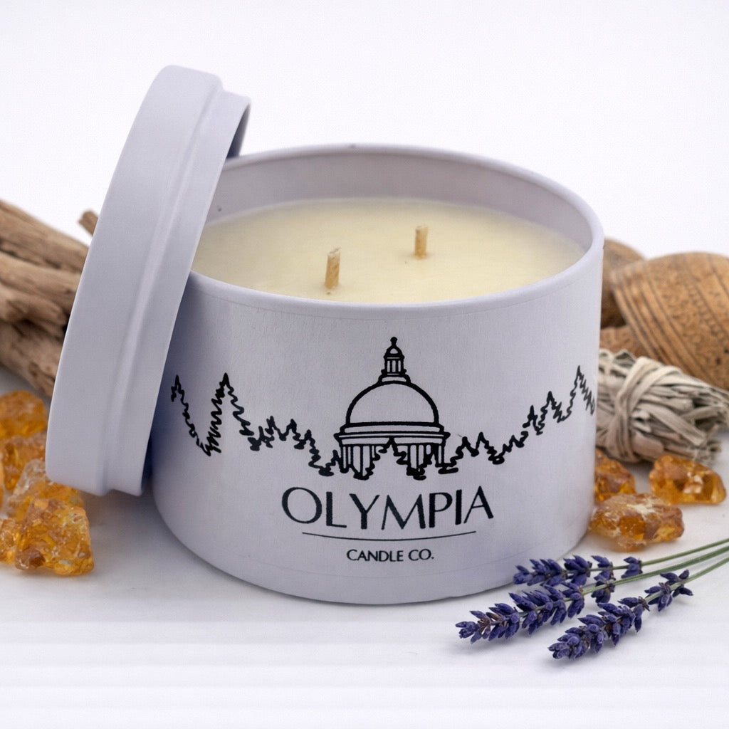 Candle in a white container with 'Olympia Candle Co.' branding, surrounded by lavender and twine on a white background.