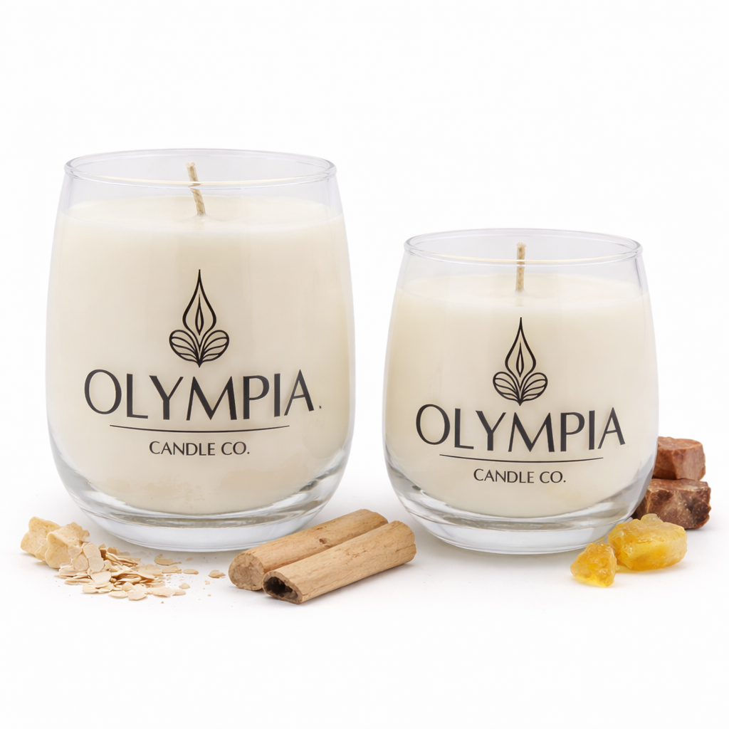Two glass candles from Olympia Candle Co. with cinnamon sticks and ginger on a white background