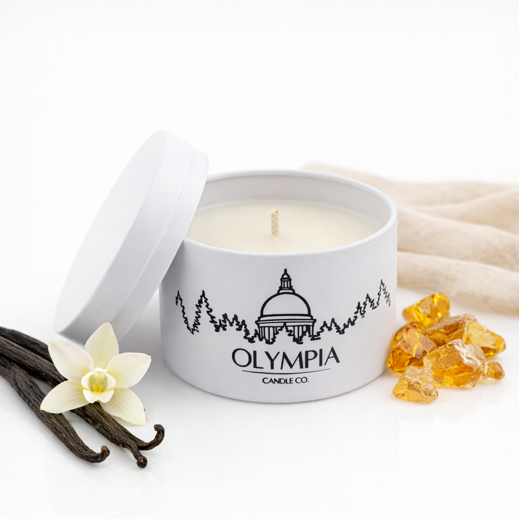 Olympia Candle Co candle with vanilla beans and vanilla flowers on a white background